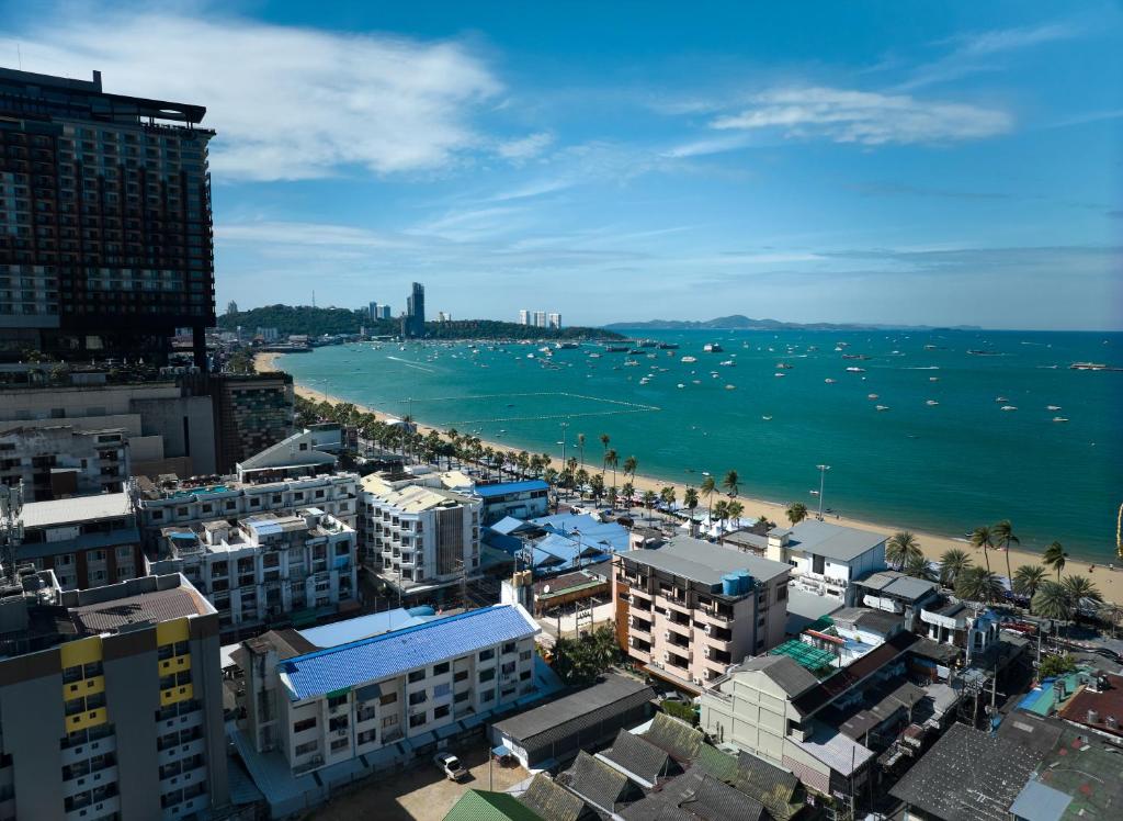 a view of a beach with buildings and the ocean at The Weekend Pattaya (Tweet Tweet Nest Pattaya) in Pattaya
