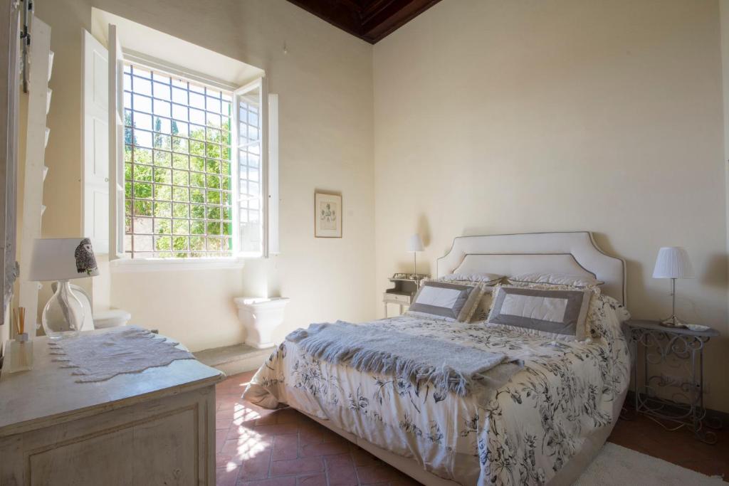 a bedroom with a large bed and a window at Pian dei Giullari Suite in Florence