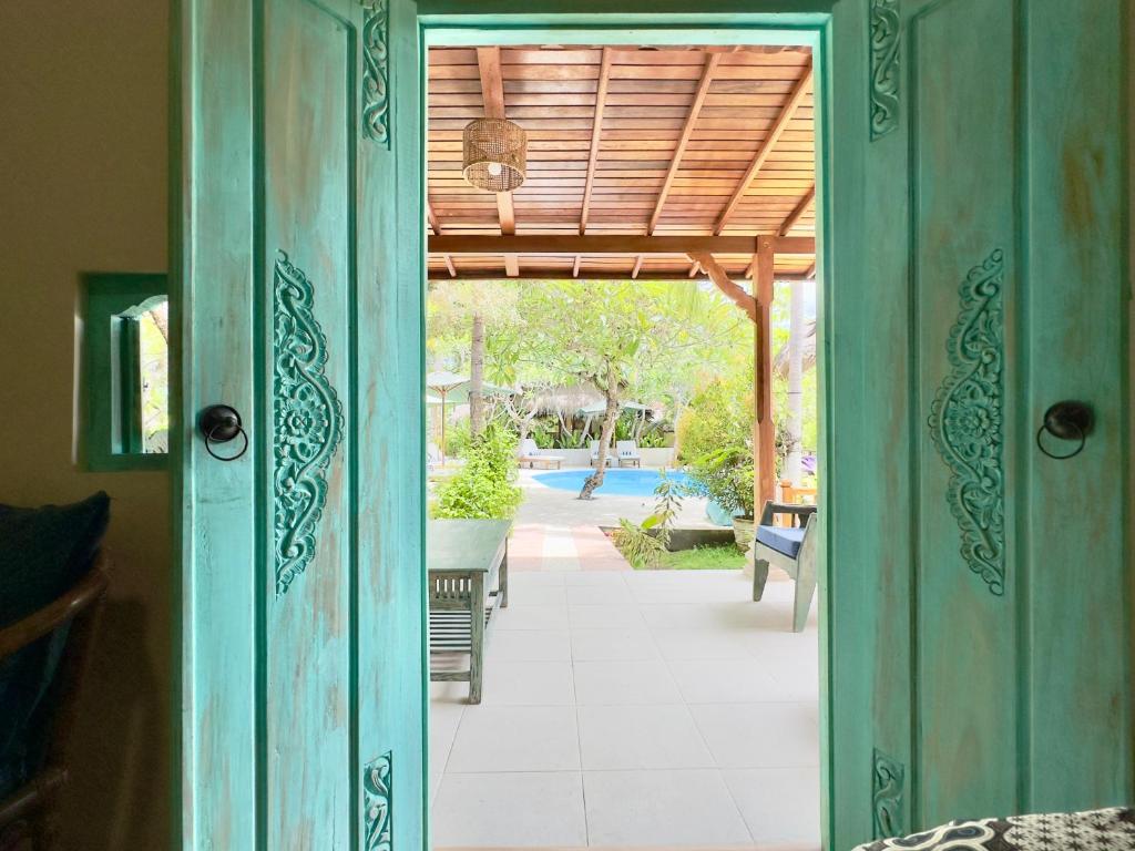 an open door to a patio with a pool at Aashaya Jasri Resort in Jasri