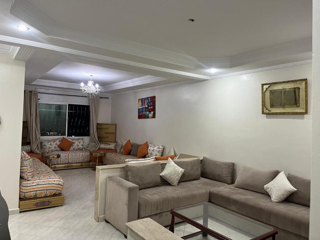 a living room with a couch and a table at appartement 1 centre ville in Kenitra