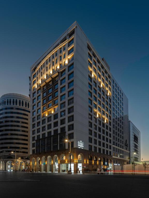 a large building with lights in front of it at MADEN Taiba HOTEL in Medina