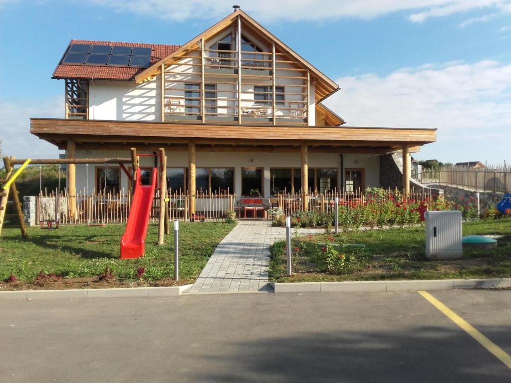a house with a playground in front of it at Guest House Eco Vila Mila in Rogaška Slatina