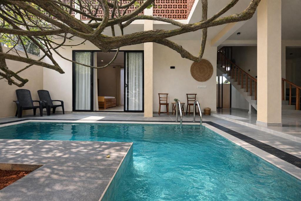 a swimming pool in the middle of a house at Gatch Villa in Unawatuna