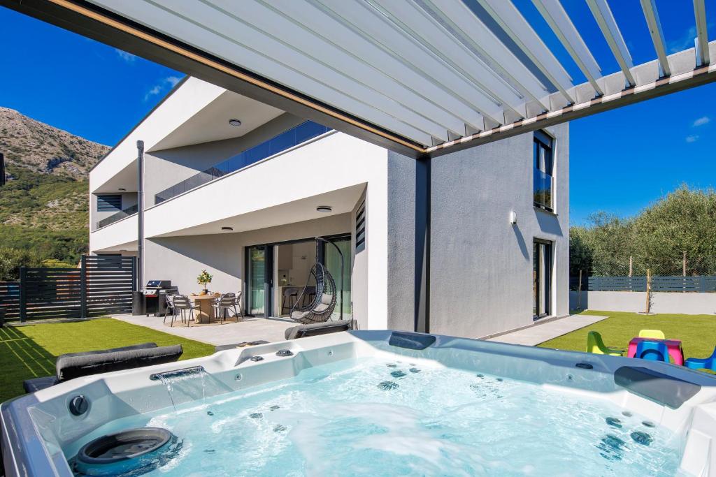 a swimming pool in the backyard of a house at Euphoria Animar & Tiema in Draga Bašćanska
