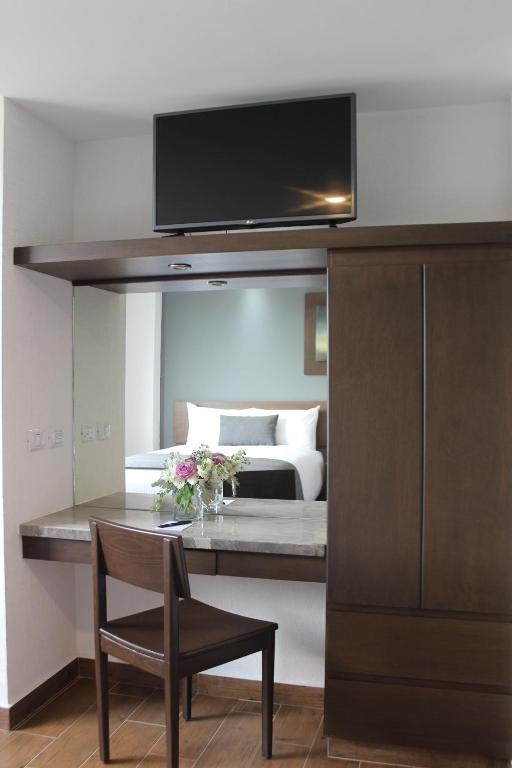 Postel nebo postele na pokoji v ubytování Eco Hotel Guadalajara Expo