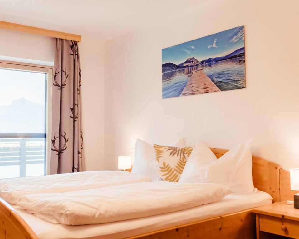 a bedroom with a large bed with a window at Ferienhof Leopold in der Grub in Ort