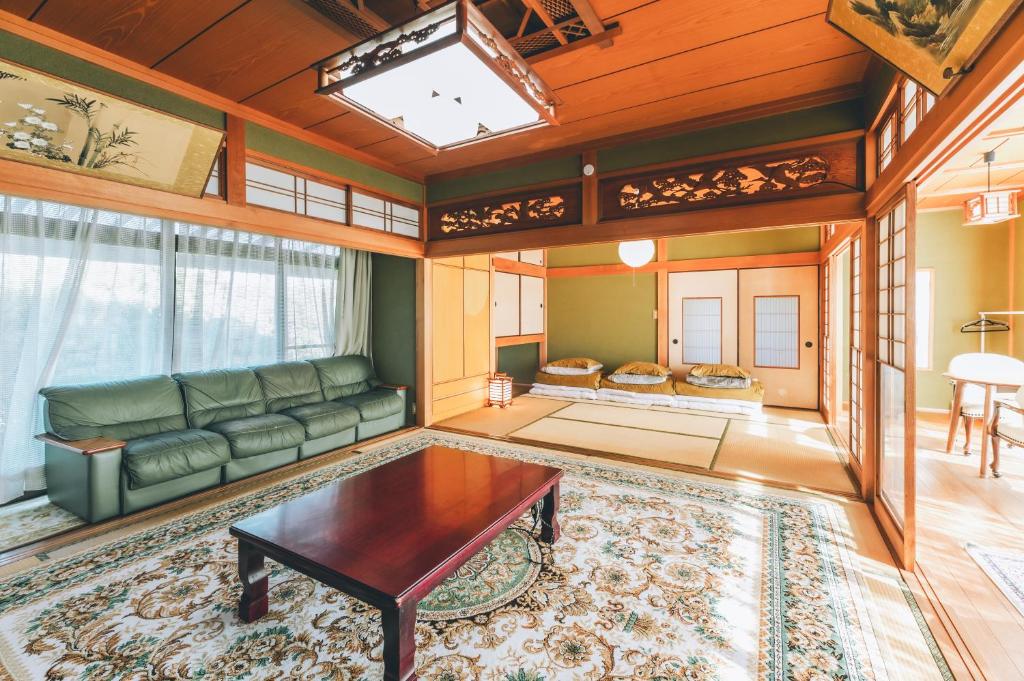 a living room with a couch and a table at keganiya 一棟貸し北九州空港近くの和風宿 in Yukuhashi