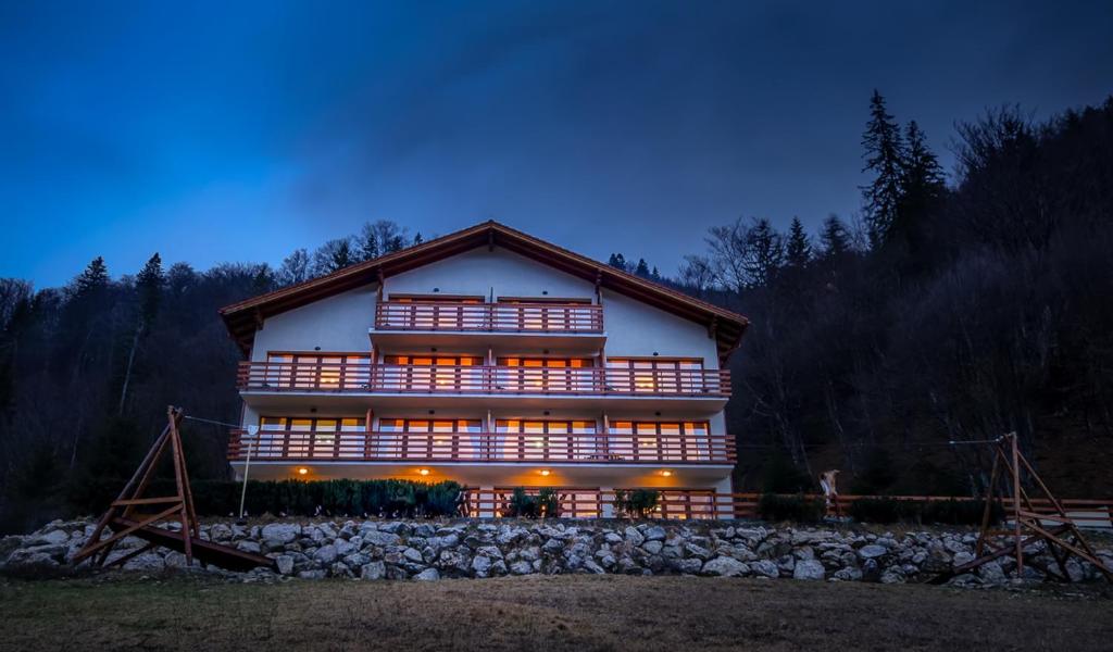 a large building with many windows on the side of it at Panorama Pietrei Craiului in Zărneşti
