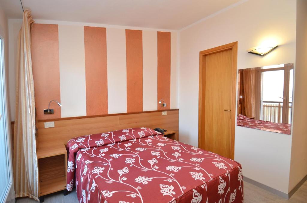 Postel nebo postele na pokoji v ubytování Hotel Righetto Fronte Mare