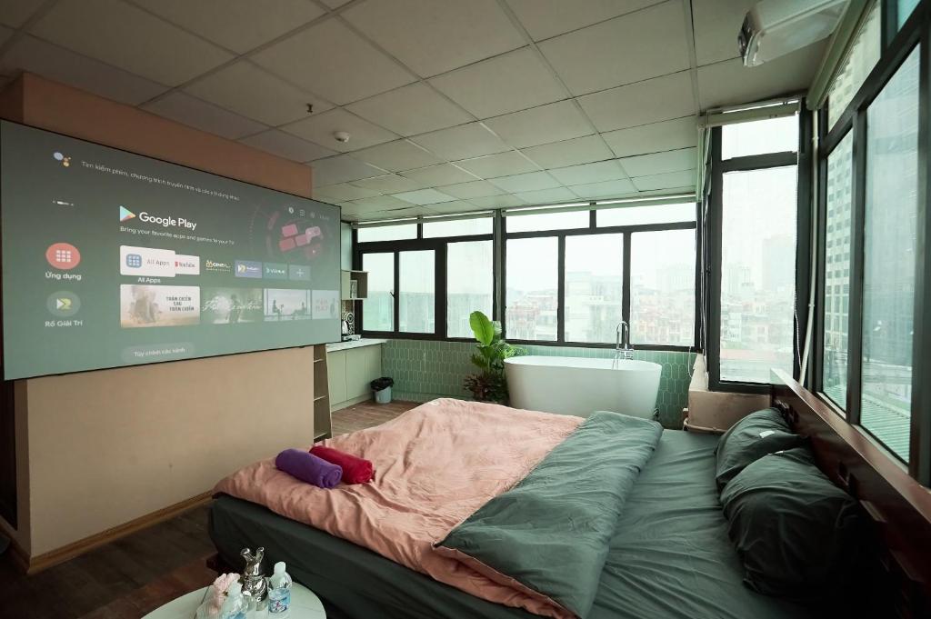 a room with a bed and a large screen at Trên Mây HST - 181 Trần Phú in Hanoi