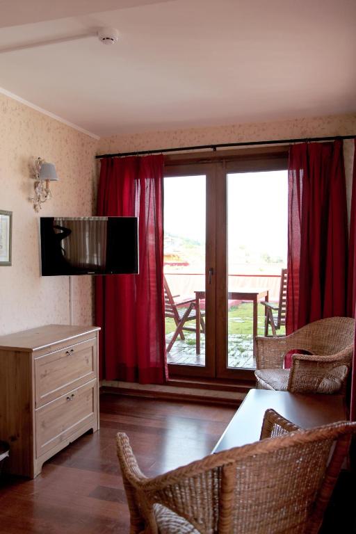 TV a/nebo společenská místnost v ubytování L'isola Guesthouse
