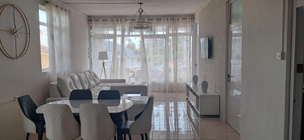 a living room with a table and a couch at Life and memory in Blue Bay