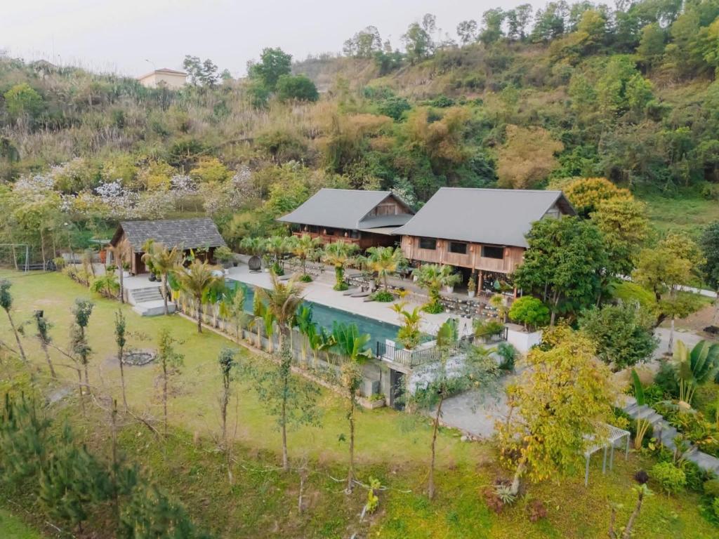 an aerial view of a resort with a pool and trees at Thung May Resort - Venuestay in Ba Vì