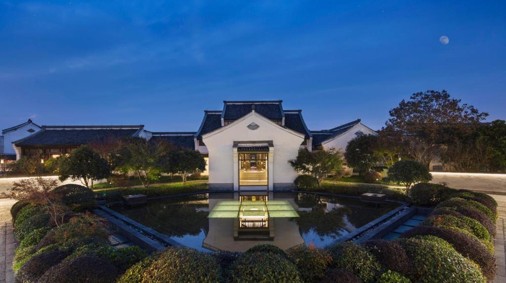 an aerial view of a house with a pond at Banyan Tree Hangzhou in Hangzhou