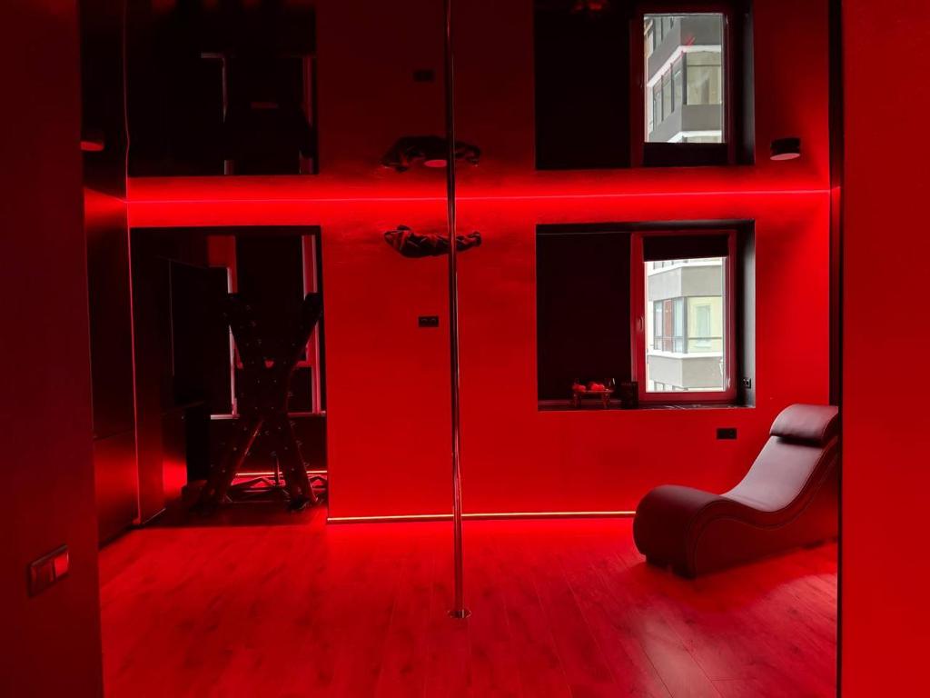 a red room with a person taking a picture of a red room at RED Тематичні Апартаменти in Zhytomyr