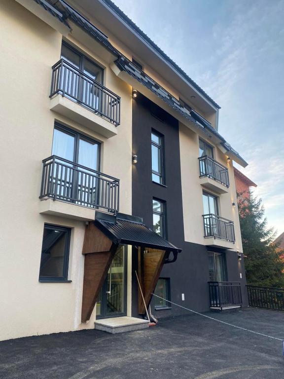 a building with a black awning in front of it at ChiaraKop in Kopaonik