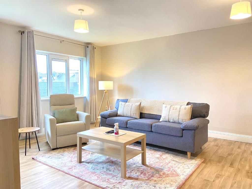 a living room with a couch and a table at Anchors Rest, Cobh in Cobh