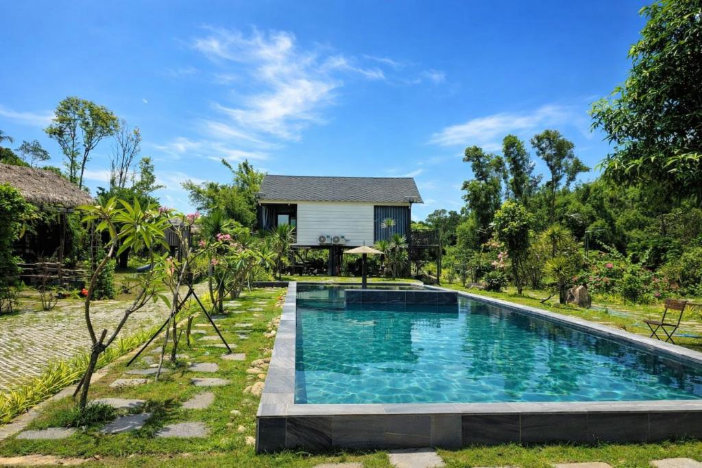 a swimming pool in front of a villa at Orchid Villa & Homestay Farm Lăng Cô in Thôn An Cư Ðông