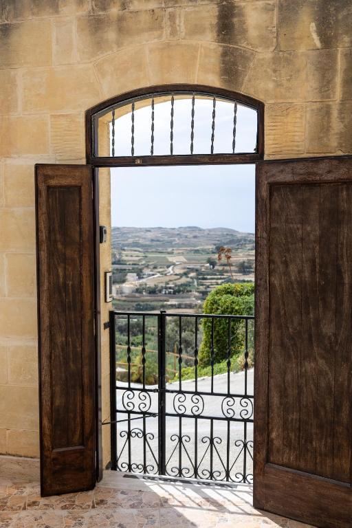 an open door to a balcony with a view at Ta Marija in Żebbuġ
