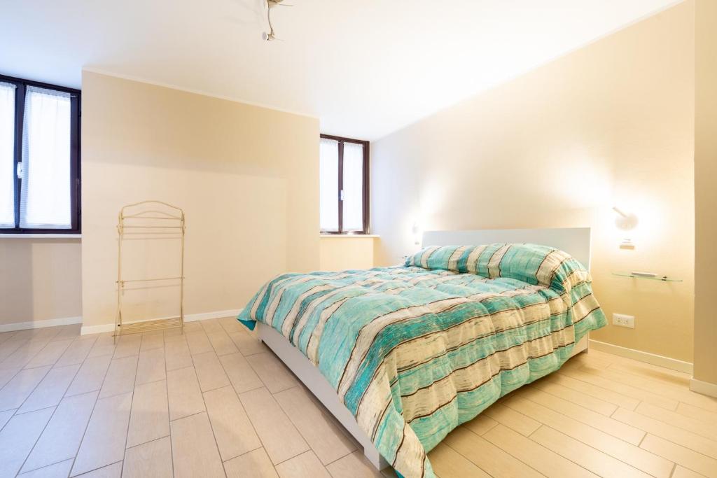 a bedroom with a bed in a room with windows at Al Lago da Lilly in Gargnano
