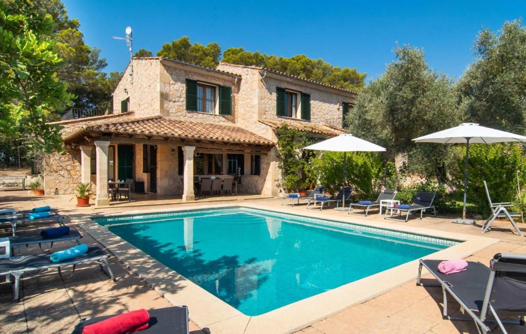 a villa with a swimming pool in front of a house at Moscari in Moscari