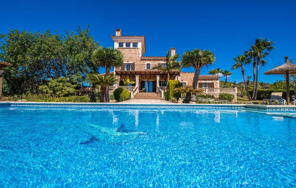 a large swimming pool in front of a house at Can Palleta Nou in S'Horta