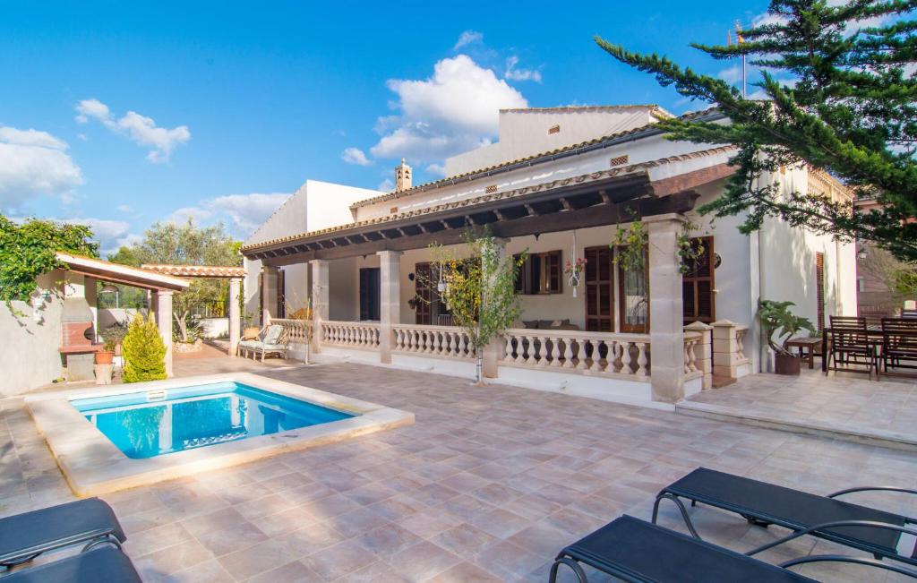 a house with a swimming pool in the yard at Pomeres Nou in Sa Coma
