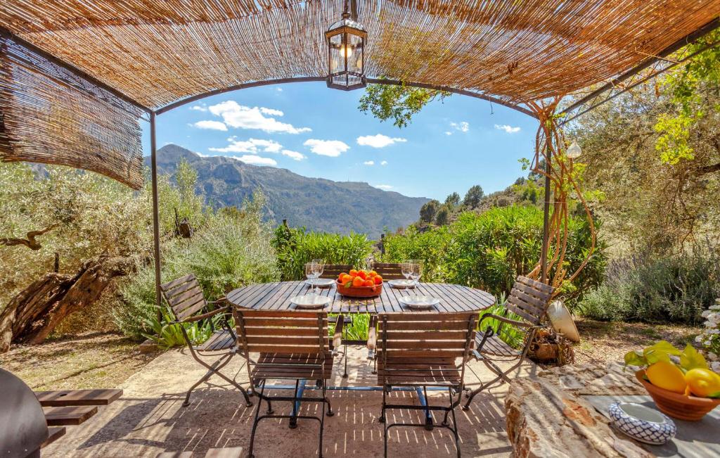 a patio with a table and chairs with a view at Rustica Es Seguers in Fornalutx