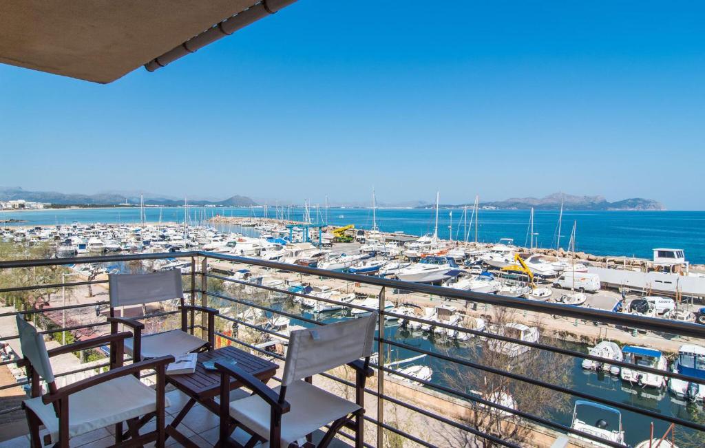 a balcony with chairs and a marina with boats at Minimal in Can Picafort
