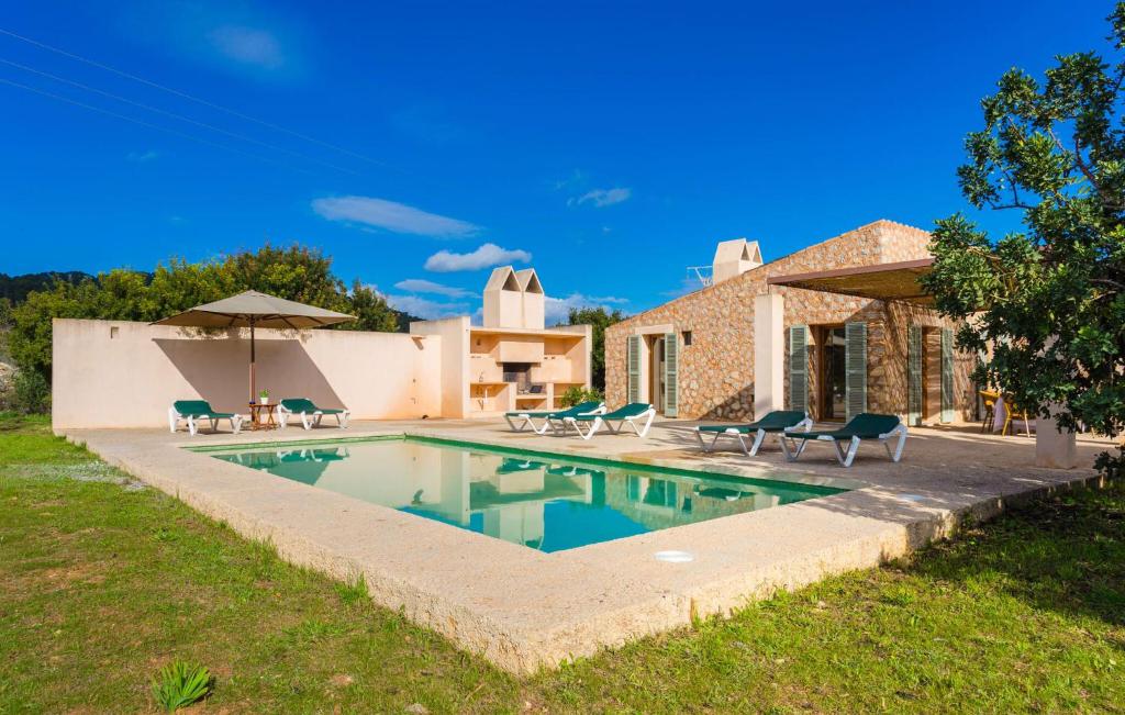 a swimming pool in front of a house at Pedra Viva in Son Servera