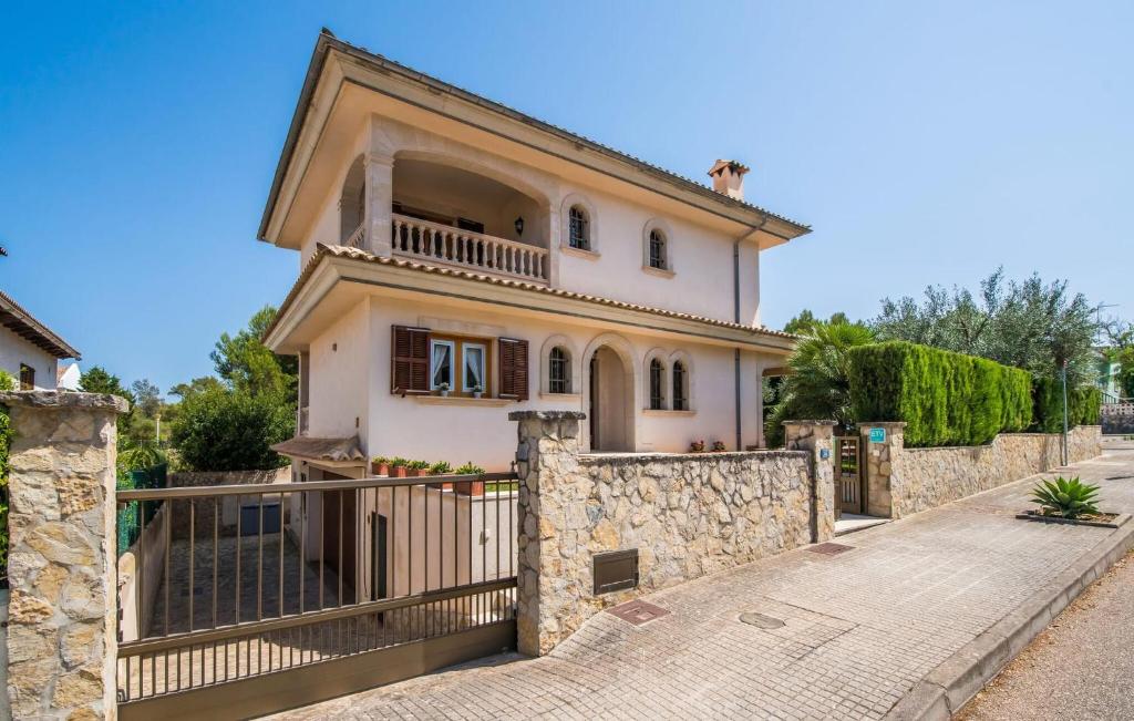 a house with a stone fence in front of it at Calma De Son Serra De Marina in Son Serra de Marina