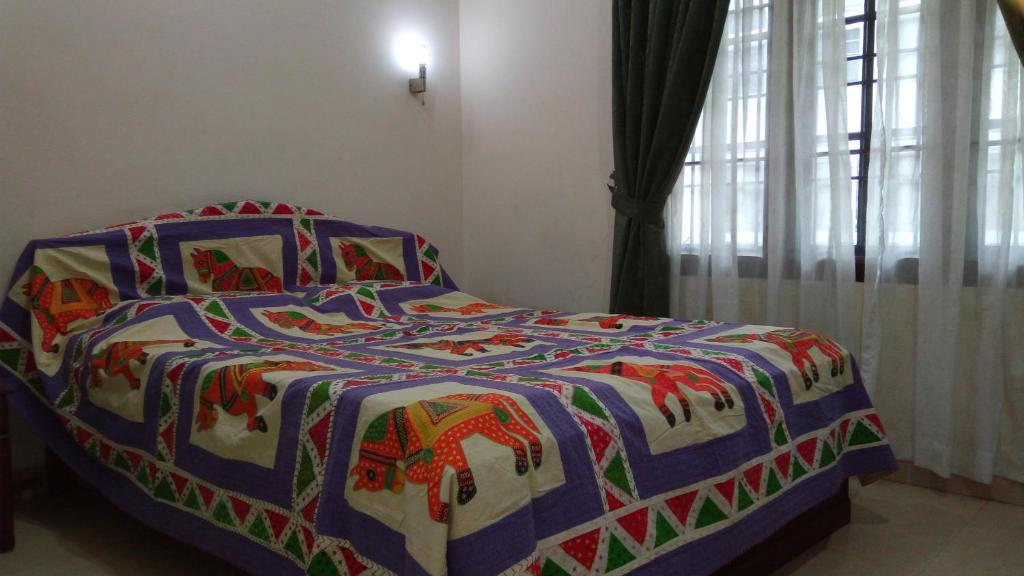 Postel nebo postele na pokoji v ubytování Elim Homestay Fort Kochi