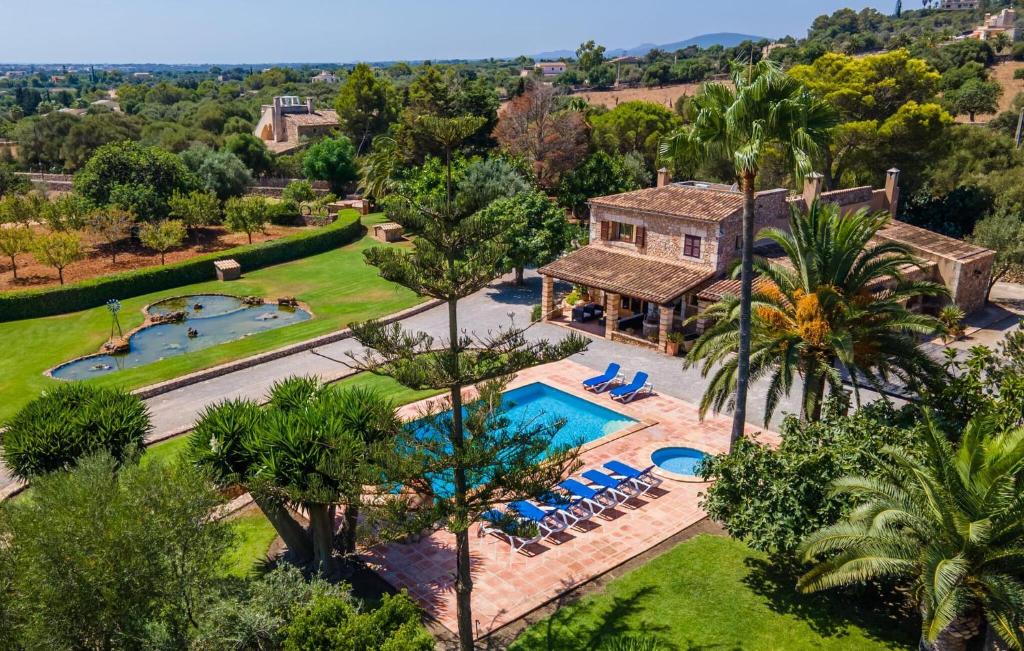 an aerial view of a house with a swimming pool at Bosco in Sa Coma