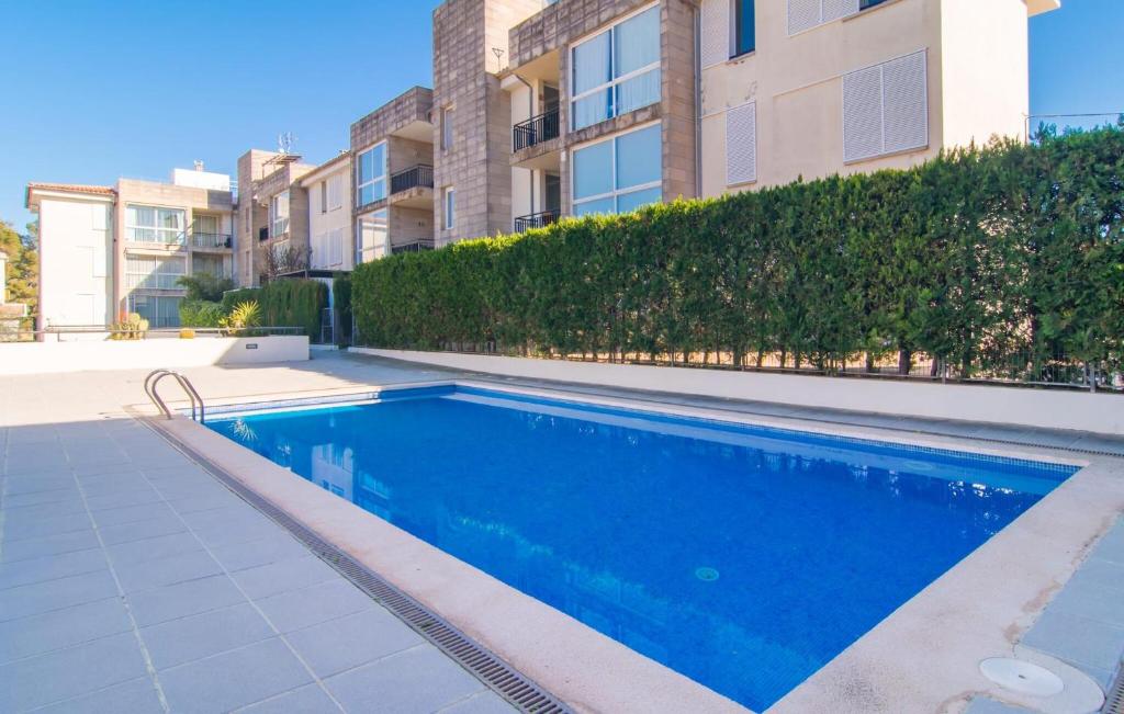 a swimming pool in front of a building at Mirella in Pollença