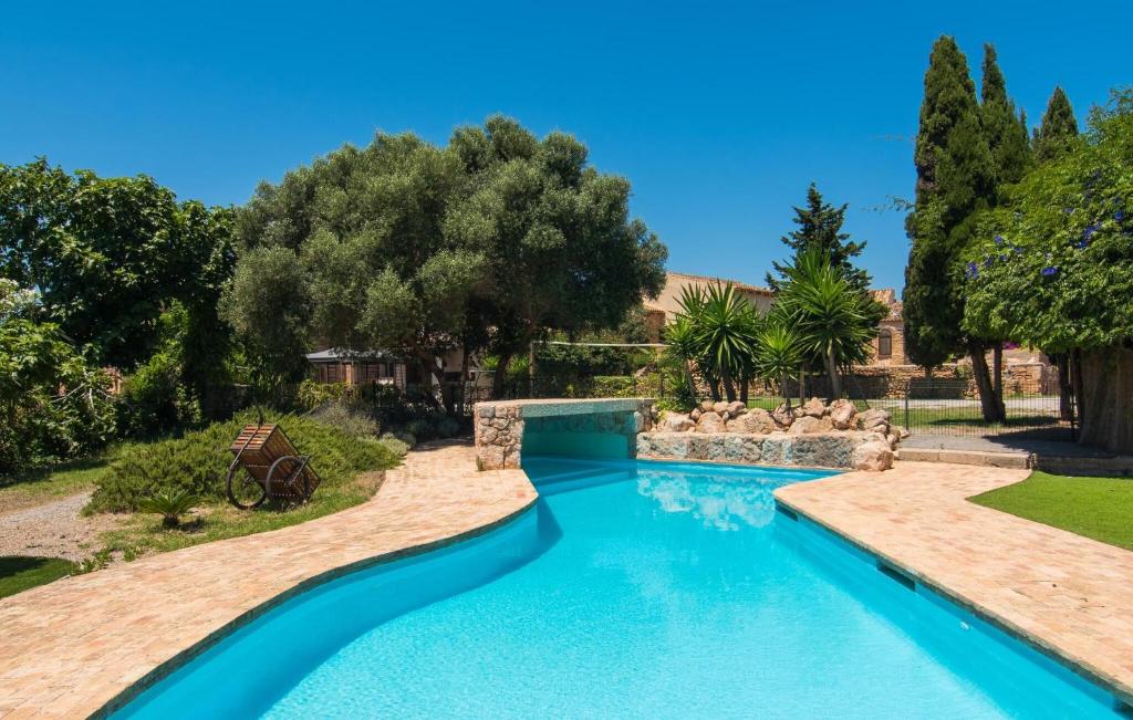 a swimming pool in a yard with a swimming pool at Son Favar in Capdepera