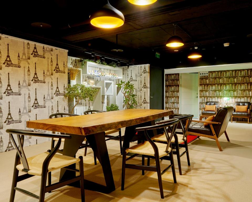 a dining room with a wooden table and chairs at Bon Hotel Taipei in Taipei
