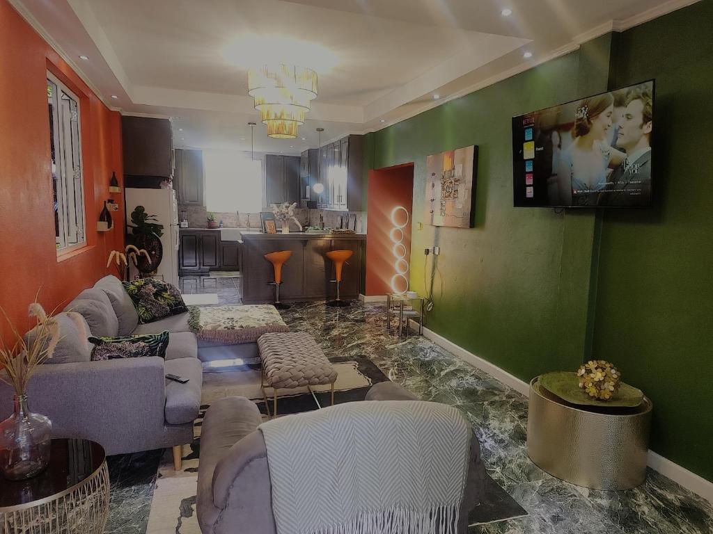 a living room filled with furniture and a flat screen tv at Hilltop Villa Chez Coco in Rodney Bay Village