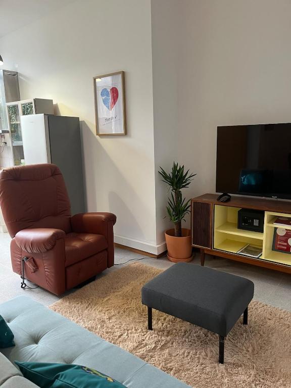 a living room with a chair and a television at 2Stay Porto in Porto
