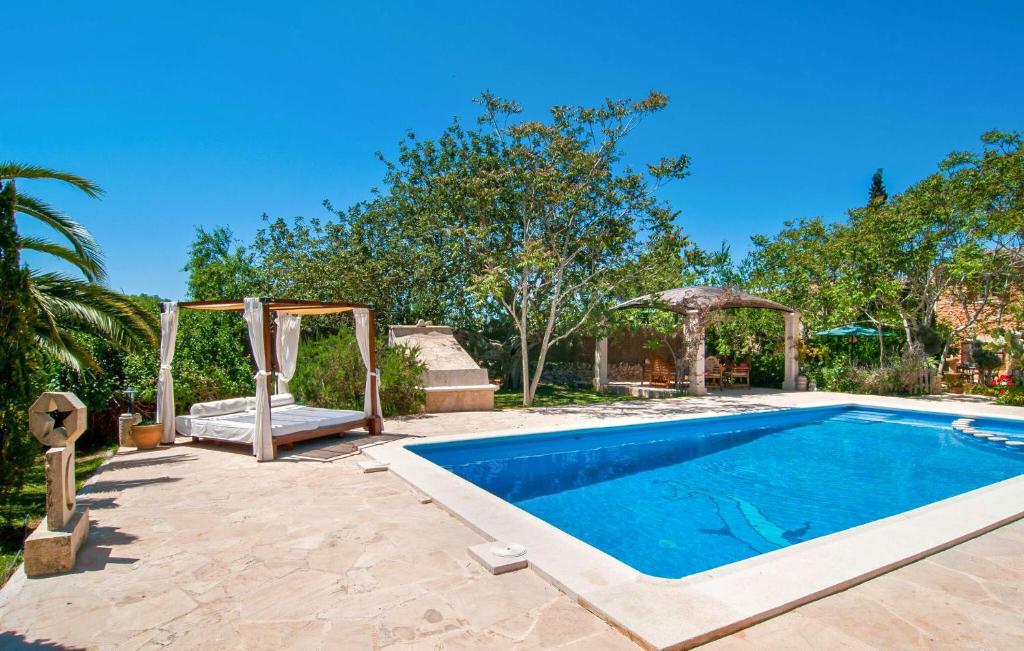 a swimming pool in a backyard with a swing at Pambola in Caʼs Concos