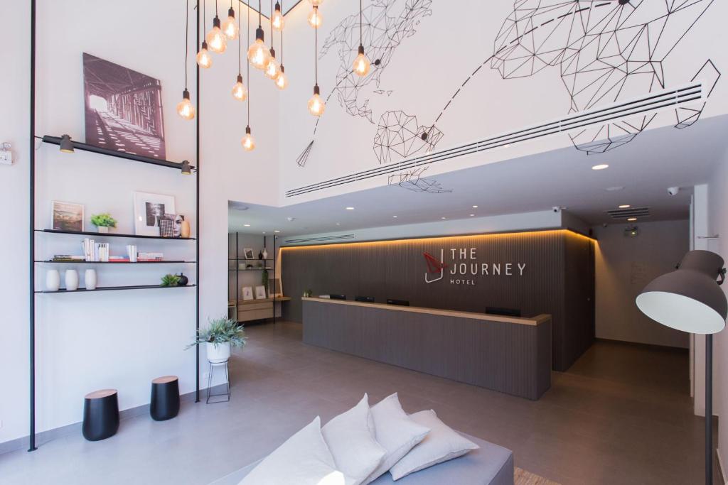 a lobby with a sign that reads the journey at The Journey Hotel Laksi in Bangkok