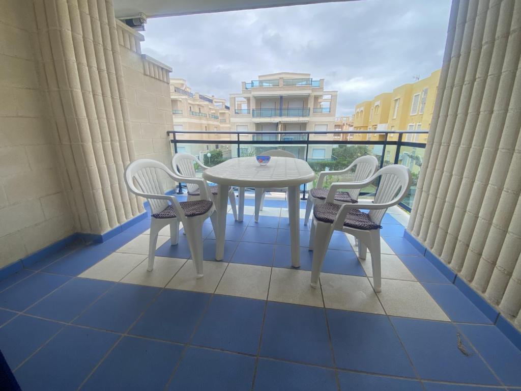 a balcony with a table and chairs on a balcony at Riumar Solo Familias Serviplaya in Playa de Xeraco