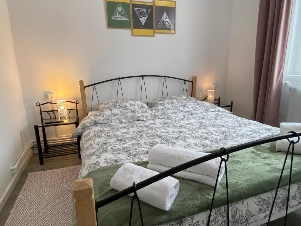a bedroom with a bed and two lamps and a window at Straja Nest in Lupeni