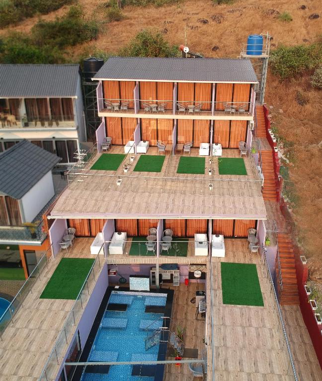 an aerial view of a building with a swimming pool at Coco 7 Beach Resort in Mandrem