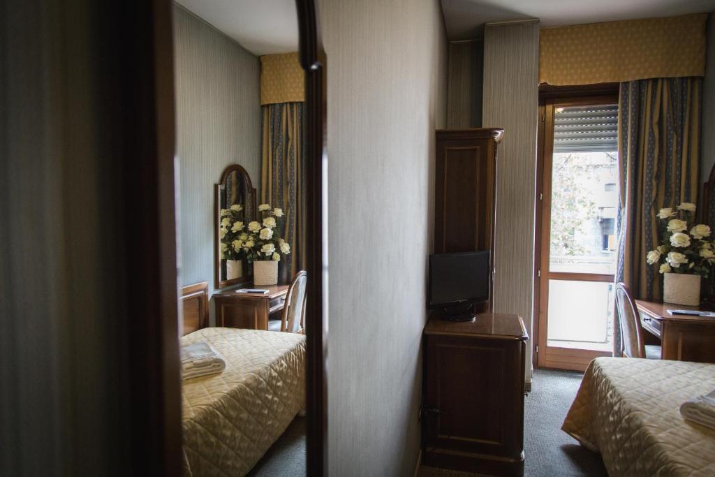 Posteľ alebo postele v izbe v ubytovaní Hotel Accursio