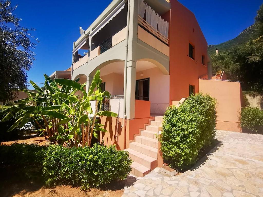 a house with stairs in front of it at Nefeli Beach Home with Hot Tub - 100m to Beach in Barbati