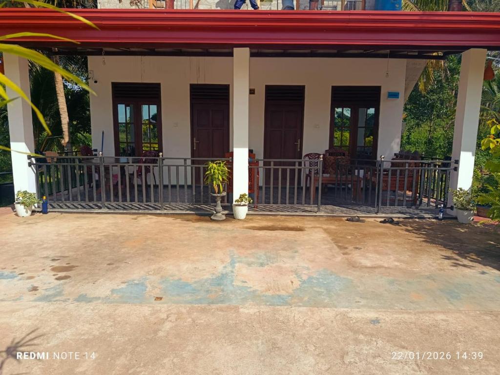 a house with a porch with chairs and tables at Lumora Resort in Horuwila