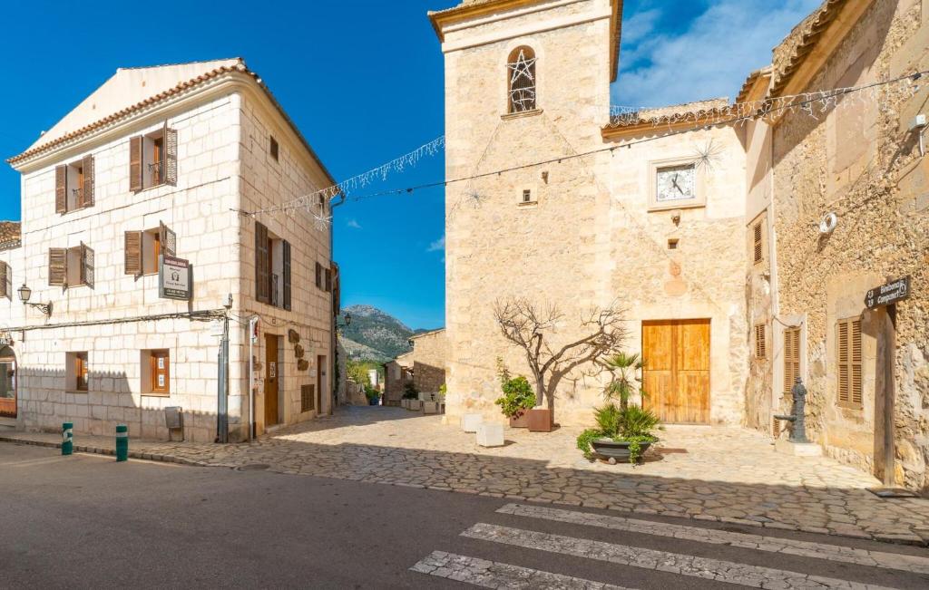 an old building with a clock tower on a street at Duplex Can Roses in Moscari