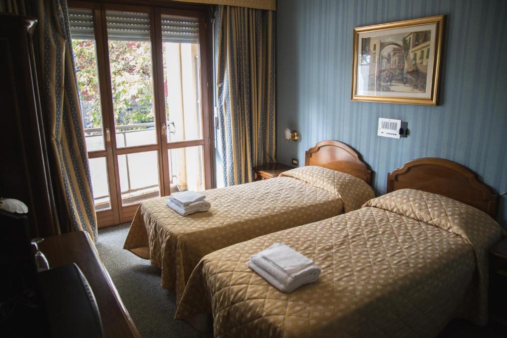 Posteľ alebo postele v izbe v ubytovaní Hotel Accursio
