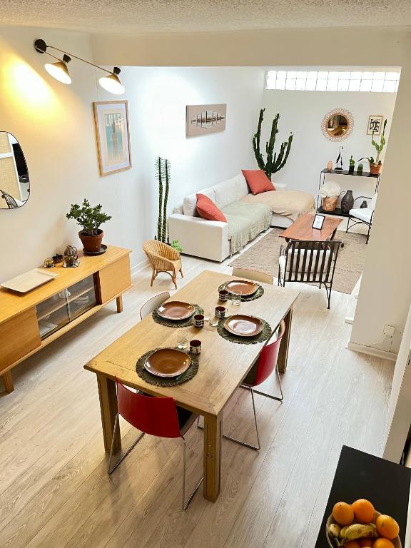 a living room with a table and a couch at L'escale Barbieux in Croix