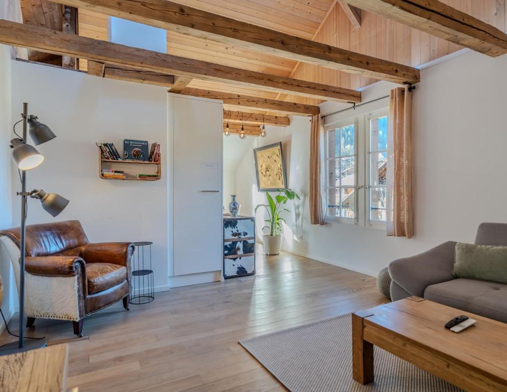 a living room with a couch and a table at Central City Apartment 2 with Mountain View in Zweisimmen